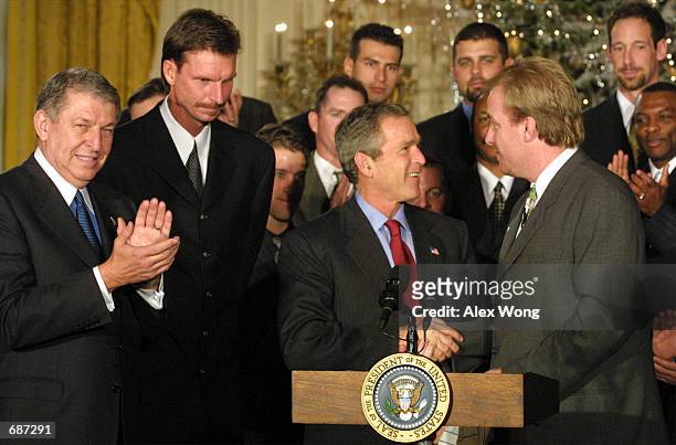 President George W. Bush shakes hands with Arizona Diamondbacks pitcher Curt Schilling as team owner Jerry Colangelo and pitcher Randy Johnson look...