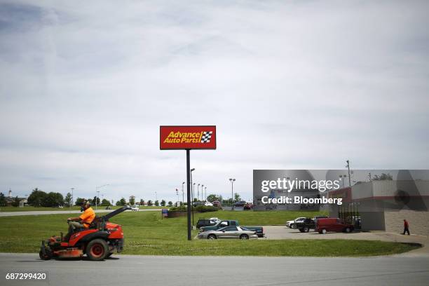 Man rides a lawnmower outside an Advanced Auto Parts Inc. Store in Shelbyville, Kentucky, U.S., on Monday, May 22, 2017. Advanced Auto Parts Inc. Is...