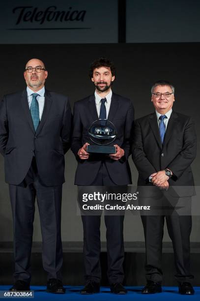 Spanish basketball player Sergio Llull of Real Madrid receives the 'MVP Movistar de la Liga Endesa 2016-2017' award from Telefonica Director Emilio...