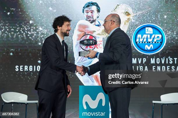 Spanish basketball player Sergio Llull of Real Madrid receives the 'MVP Movistar de la Liga Endesa 2016-2017' award from Telefonica Director Emilio...