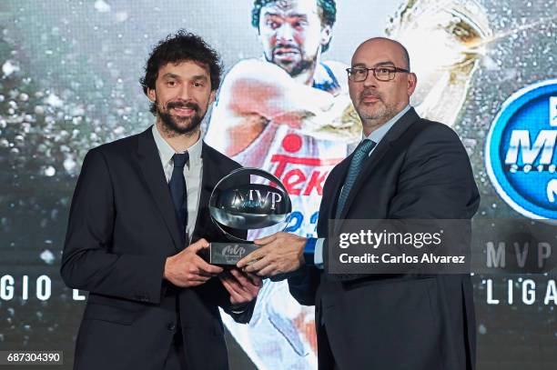 Spanish basketball player Sergio Llull of Real Madrid receives the 'MVP Movistar de la Liga Endesa 2016-2017' award from Telefonica Director Emilio...