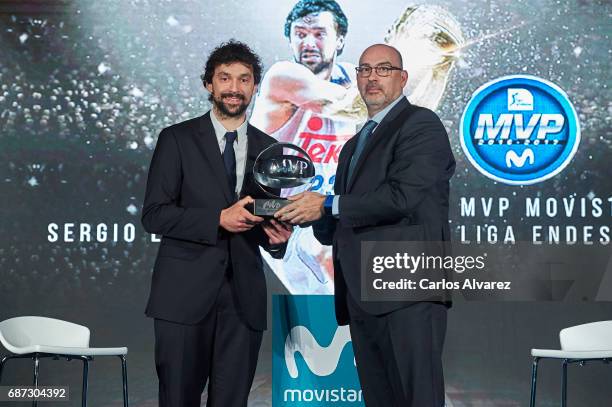 Spanish basketball player Sergio Llull of Real Madrid receives the 'MVP Movistar de la Liga Endesa 2016-2017' award from Telefonica Director Emilio...