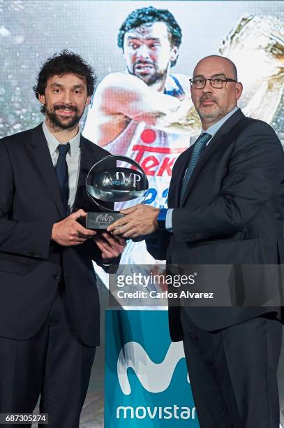 Spanish basketball player Sergio Llull of Real Madrid receives the 'MVP Movistar de la Liga Endesa 2016-2017' award from Telefonica Director Emilio...
