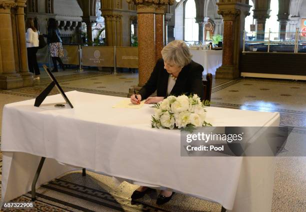 Prime Minister Theresa May writes a message to the people of Manchester at Manchester Town Hall on May 23, 2017 in Manchester, England. A 23-year-old...