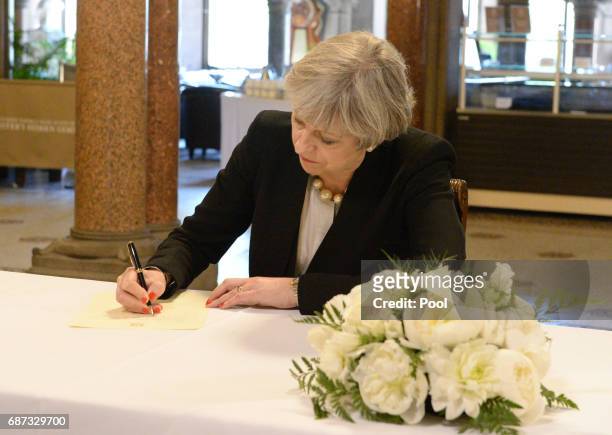 Prime Minister Theresa May writes a message to the people of Manchester at Manchester Town Hall on May 23, 2017 in Manchester, England. A 23-year-old...