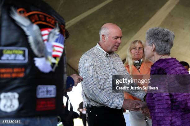 Republican congressional candidate Greg Gianforte greets supporters during a campaign meet and greet at Lions Park on May 23, 2017 in Great Falls,...