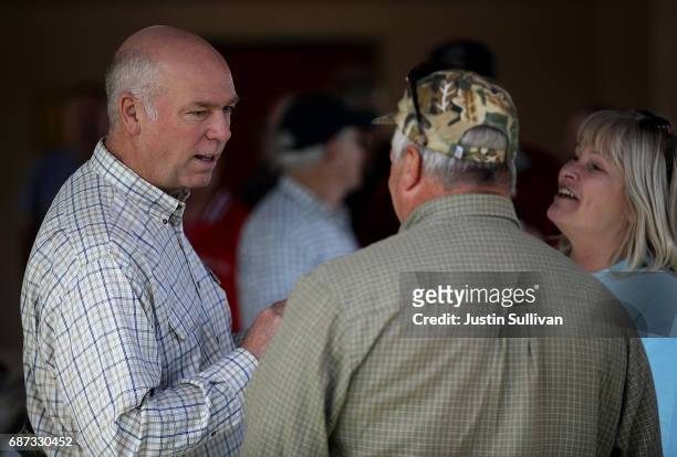 Republican congressional candidate Greg Gianforte talks with supporters during a campaign meet and greet at Lions Park on May 23, 2017 in Great...