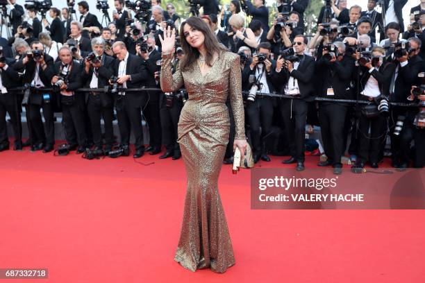 Italian actress and master of ceremonies Monica Bellucci waves as she arrives on May 23, 2017 for the '70th Anniversary' ceremony of the Cannes Film...