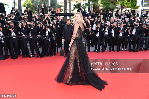 South African-US actress Charlize Theron poses as she arrives on May 23, 2017 for the '70th Anniversary' ceremony of the Cannes Film Festival in...