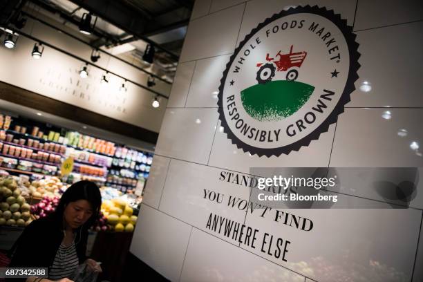 Signage is displayed at a Whole Foods Market Inc. Location in New York, U.S., on Tuesday, May 22, 2017. Whole Foods Market Inc., facing pressure from...