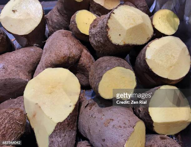 heap of yellow yam in a market - yams day stock pictures, royalty-free photos & images