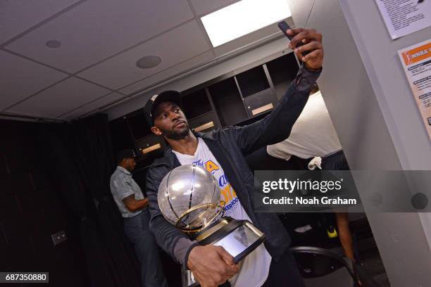 Ian Clark of the Golden State Warriors takes a 'selfie' with the Western Conference Championship Trophy after winning Game Four of the Western...