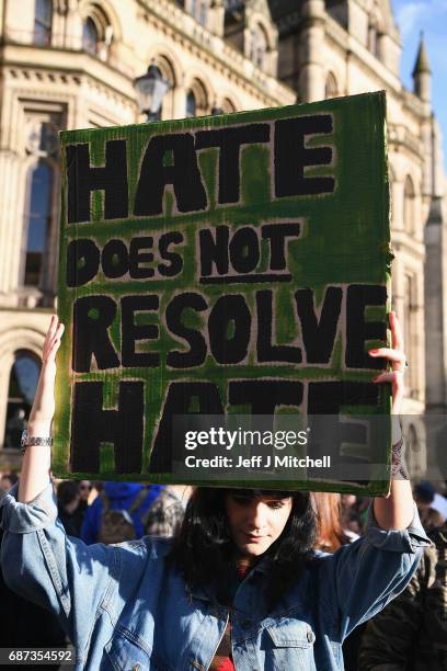 Member of the public holds a sign during a vigil, to honour the victims of Monday evening's terror attack, at Albert Square on May 23, 2017 in...