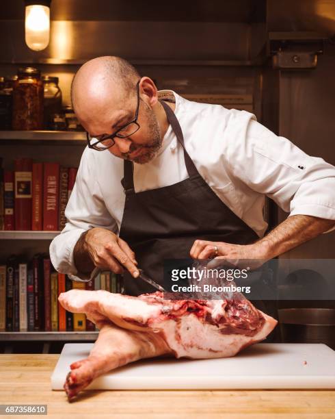 Adam Kaye, vice president of culinary affairs at the Blue Hill at Stone Barns restaurant, butchers a Berkshire pork leg in Pocantico Hills, New York,...