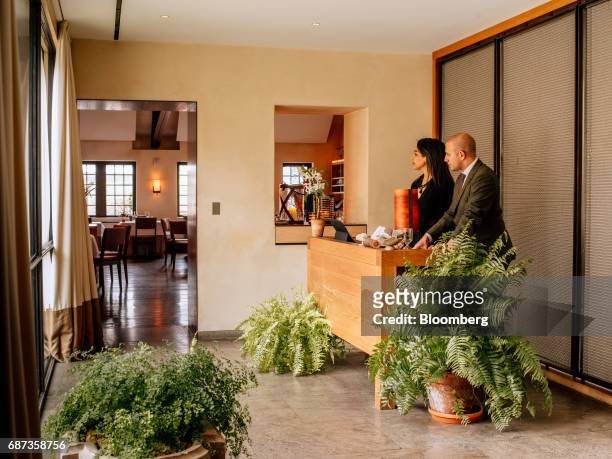 Hosts stand at the reception desk of the Blue Hill at Stone Barns restaurant in Pocantico Hills, New York, U.S., on Friday, April 21, 2017. As...