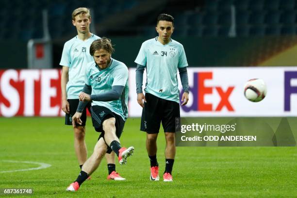 Ajax Danish Midfielder Lasse Schone shoots the ball as his teammates Ajax Dutch midfielder Frenkie de Jong and Ajax Dutch midfielder Abdelhak Nouri...