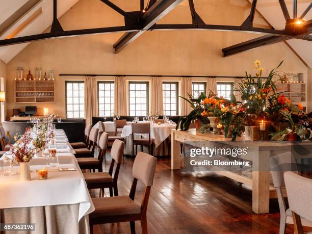 Tables sit inside the dining room of the Blue Hill at Stone Barns restaurant in Pocantico Hills, New York, U.S., on Friday, April 21, 2017. As...