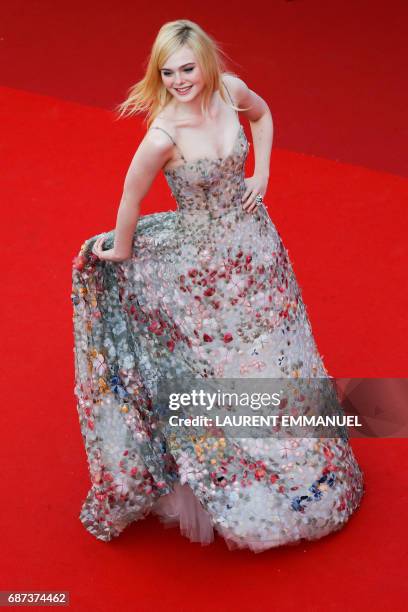 Actress Elle Fanning arrives on May 23, 2017 for the '70th Anniversary' ceremony of the Cannes Film Festival in Cannes, southern France. / AFP PHOTO...