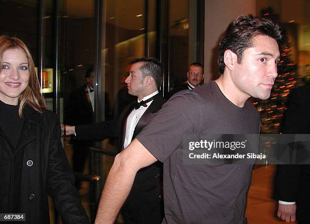 Boxer Oscar De La Hoya leaves the Beverly Hilton Hotel with his wife, singer Millie Corretjer December 12, 2001 in Beverly Hills, CA.