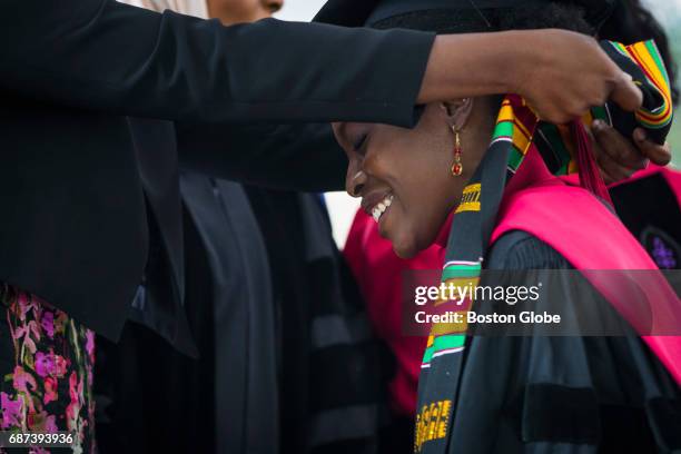 Law Student graduate Esther Agbaje smiles as she has a stole made of African kente cloth draped around her neck as she takes part in the Black...