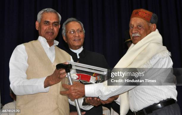 Himachal Pradesh Governor Acharya Dev Vrat presenting award to Subedar Ruliya Ram, father of Ashoka Chakra winner Major Sudhir Walia, during the...