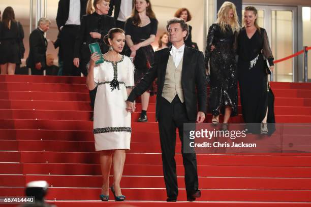 Carole Bouquet and Philippe Sereys de Rothschild leave the "Hikari " screening during the 70th annual Cannes Film Festival at Palais des Festivals on...