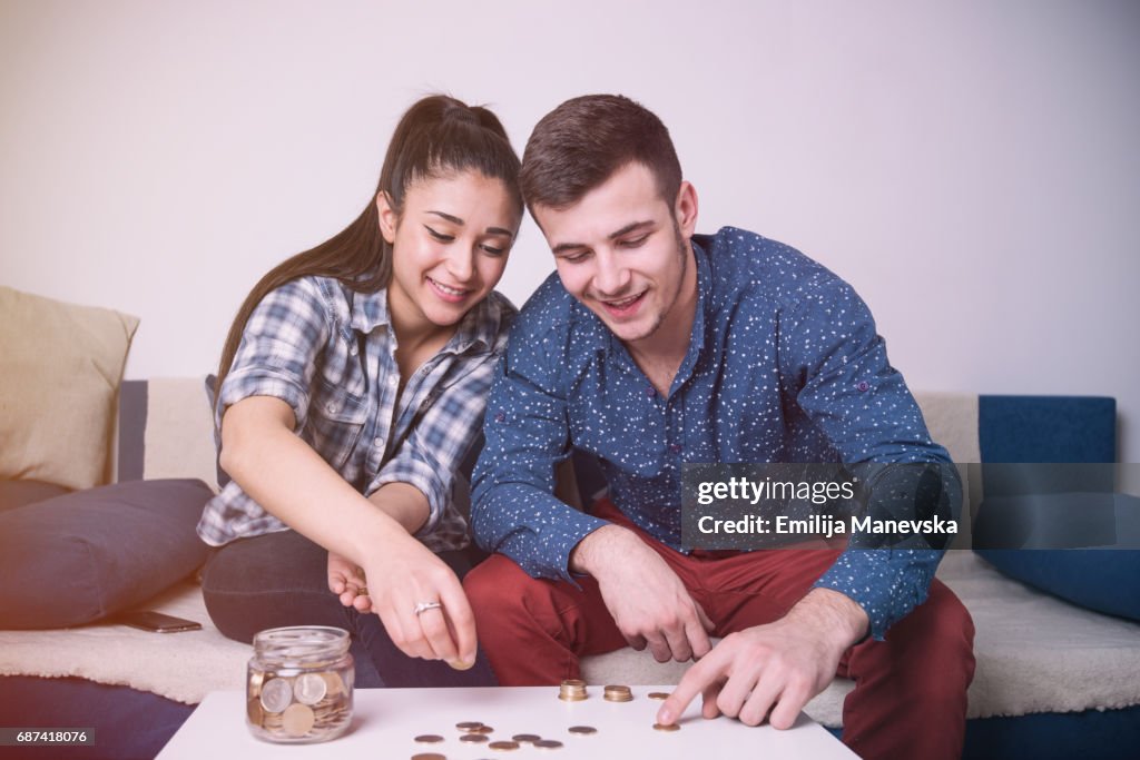 Young couple counting money