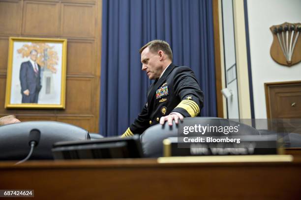 Michael Rogers, director of the National Security Agency , speaks to a committee member before a House Armed Services Subcommittee hearing in...