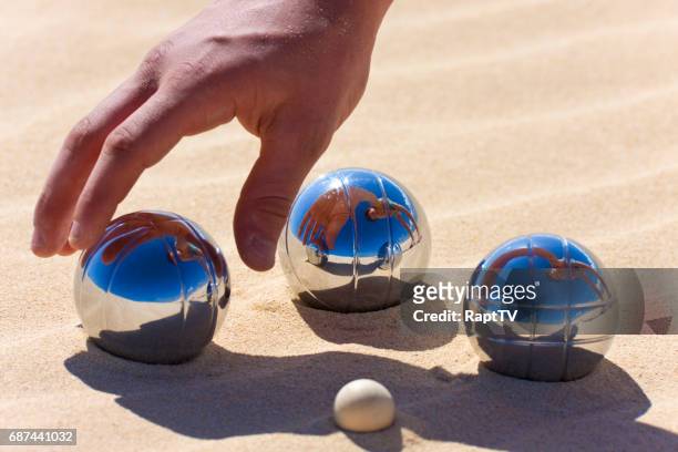 playing boules or petanque - petanque stock pictures, royalty-free photos & images