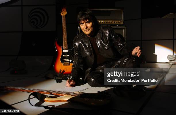 Italian singer-songwriter Renato Zero portrayed while sitting on the floor with paper and pen at Mediaset TV studios before the shooting of the TV...