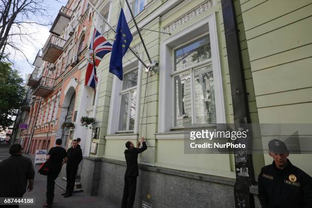 Employees of the British Embassy in Kiev, Ukraine fly a flag at half-mast, Tuesday, May 23, 2017. An apparent suicide bomber attacked an Ariana...