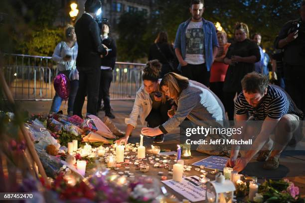 Members of the public attend a candlelit vigil, to honour the victims of Monday evening's terror attack, at Albert Square on May 23, 2017 in...