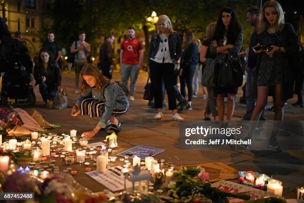 Members of the public attend a candlelit vigil, to honour the victims of Monday evening's terror attack, at Albert Square on May 23, 2017 in...