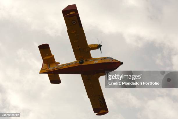 Vigili del Fuoco Canadair water bomber seen from below while it contains the fires - arsons, almost surely - that burnt oown more than 1400 acres of...