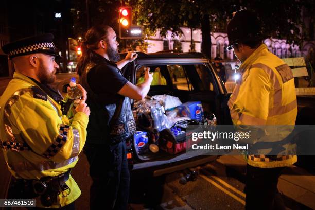 Des Richardson, owner of Canine Motorcycle Recovery, hands out free food and drink to police and public following an evening vigil outside the Town...