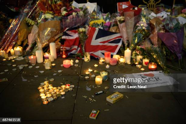 Candles and floral tributes are seen, following an evening vigil outside the Town Hall on May 23, 2017 in Manchester, England. An explosion occurred...