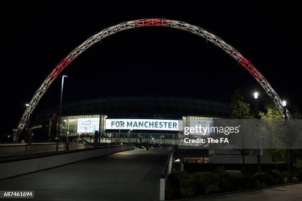 Wembley Stadium Lights up in tribute to the victims of the Manchester attacks at Wembley Stadium on May 23, 2017 in London, England.