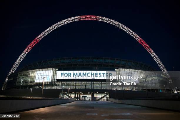 Wembley Stadium Lights up in tribute to the victims of the Manchester attacks at Wembley Stadium on May 23, 2017 in London, England.