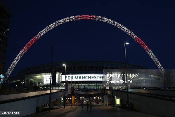 Wembley Stadium Lights up in tribute to the victims of the Manchester attacks at Wembley Stadium on May 23, 2017 in London, England.