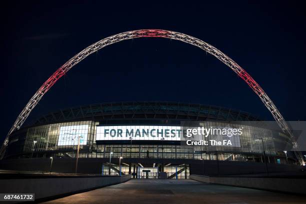 Wembley Stadium Lights up in tribute to the victims of the Manchester attacks at Wembley Stadium on May 23, 2017 in London, England.