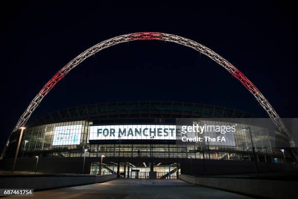 Wembley Stadium Lights up in tribute to the victims of the Manchester attacks at Wembley Stadium on May 23, 2017 in London, England.
