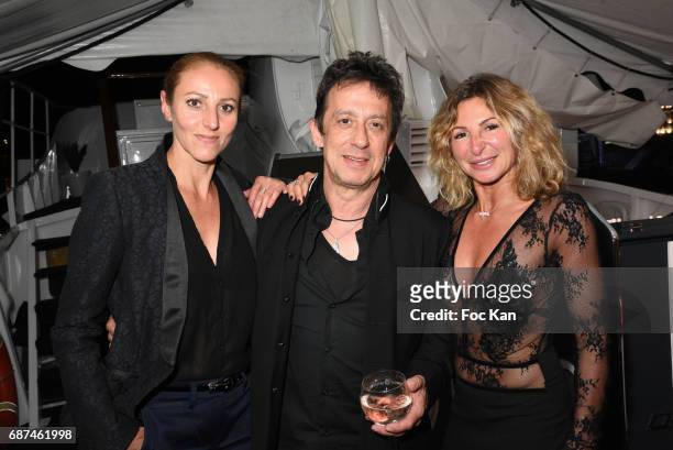 Make up artist Isabelle Theviot, composer Eric Serra and hair stylist Sarah Guetta attend the Technikart Boat Party during the 70th annual Cannes...