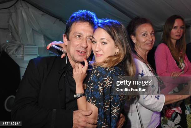 Composer Eric Serra and Julie Peugeot attend the Technikart Boat Party during the 70th annual Cannes Film Festival at on May 22, 2017 in Cannes,...