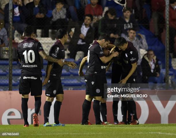 Argentina's Lanus players celebrate a goal against Uruguay's Nacional during their Libertadores Cup football match at the Parque Central stadium in...