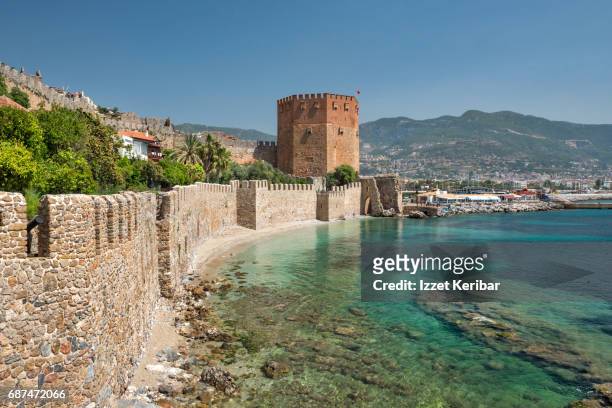 red tower and old walls of the alanya fortress, antalya turkey - antalya stock pictures, royalty-free photos & images