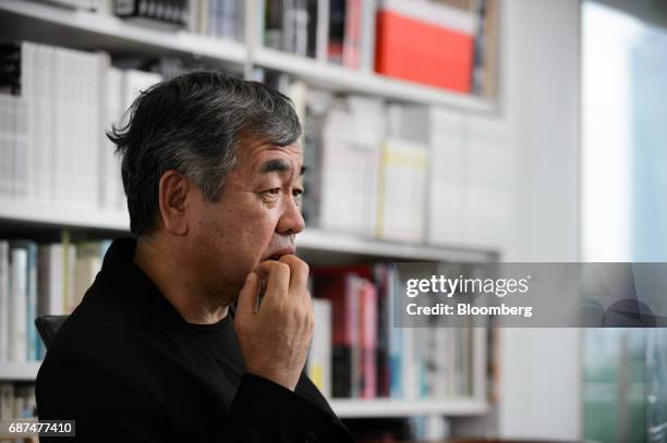 Kengo Kuma, Japanese architect, pauses during an interview in Tokyo, Japan, on Friday, May 12, 2017. Using Japanese lumber for the centerpiece...