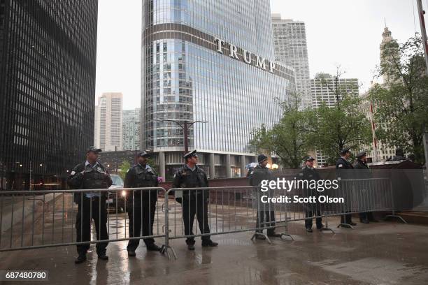 Police stand guard near Trump Tower as they wait for demonstrators fighting for a $15-per-hour minimum wage to march past on May 23, 2017 in Chicago,...
