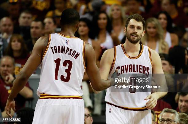 Tristan Thompson and Kevin Love of the Cleveland Cavaliers react in the first half against the Boston Celtics during Game Four of the 2017 NBA...