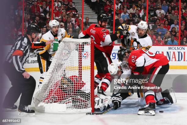 Marc Methot and Erik Karlsson of the Ottawa Senators battle for a loose puck with Trevor Daley, Carl Hagelin and Sidney Crosby of the Pittsburgh...