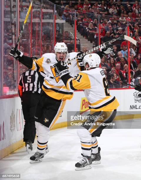 Evgeni Malkin of the Pittsburgh Penguins celebrates with teammate Phil Kessel after scoring a second period goal on the Ottawa Senators in Game Six...